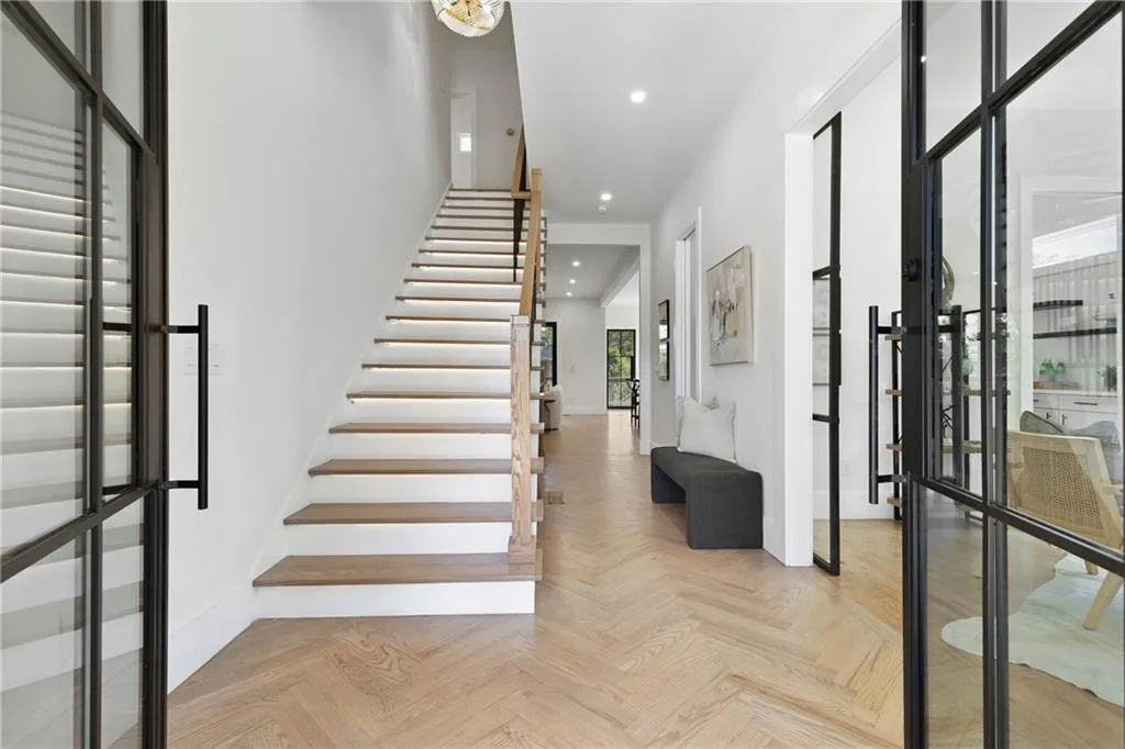 Entrance foyer with stairs and recessed lighting