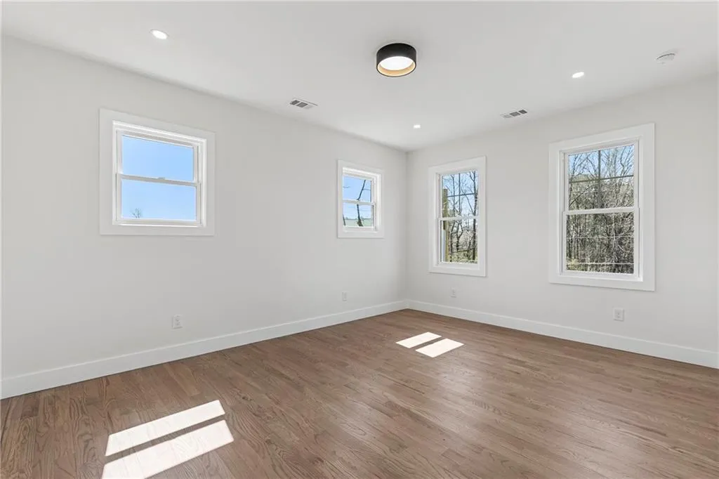 Unfurnished room featuring wood finished floors and recessed lighting