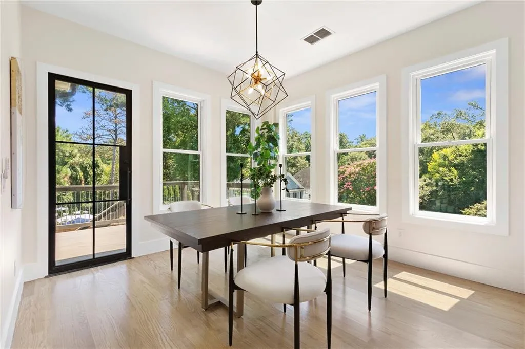 Sunroom featuring healthy amount of natural light and a chandelier