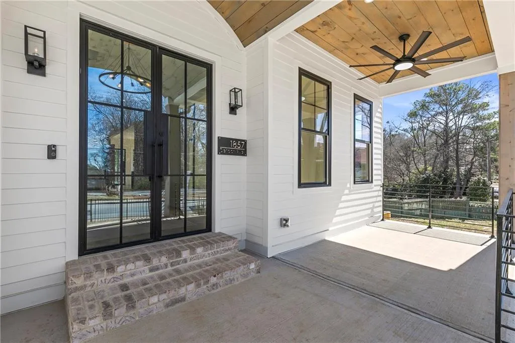 View of exterior entry with french doors and ceiling fan