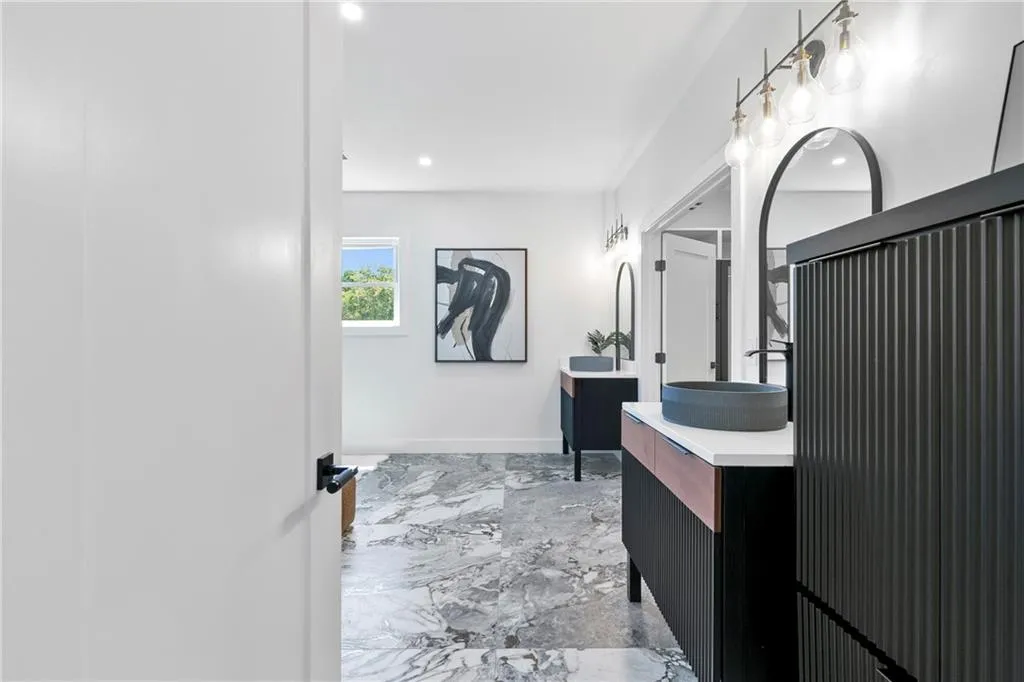 Full bathroom with vanity, light marble finish flooring, and recessed lighting
