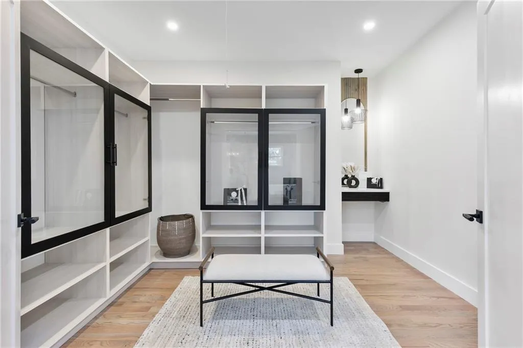 Walk in closet with light wood finished floors