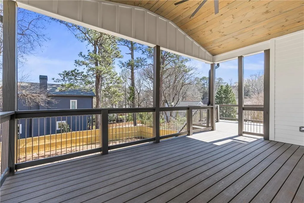 Wooden terrace featuring a ceiling fan