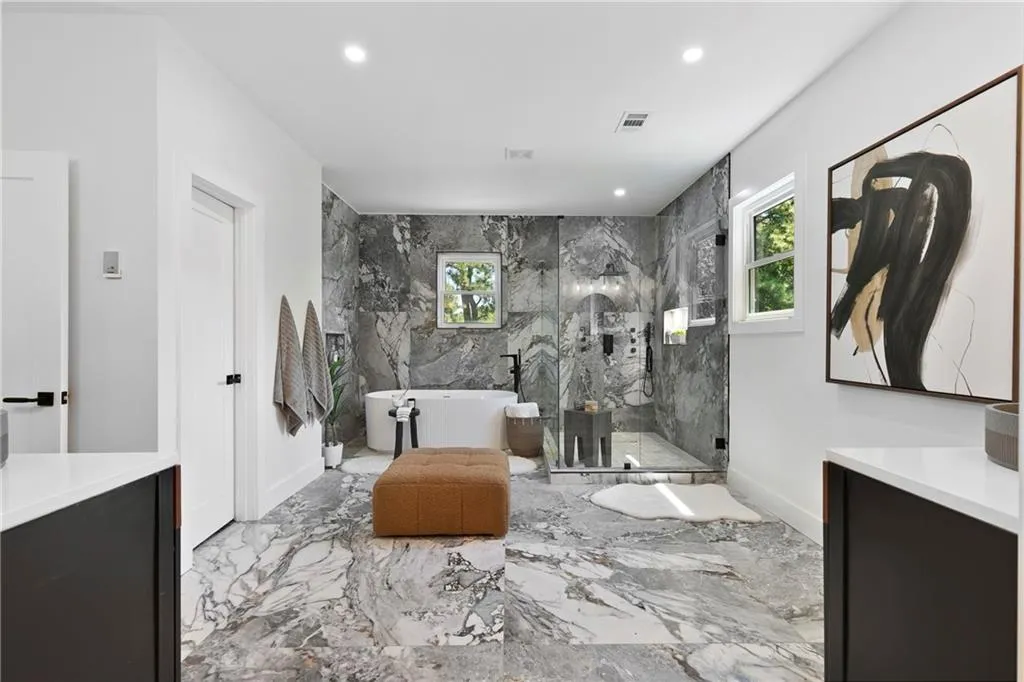 Full bathroom with a freestanding bath, a marble finish shower, recessed lighting, vanity, and marble tiled floors