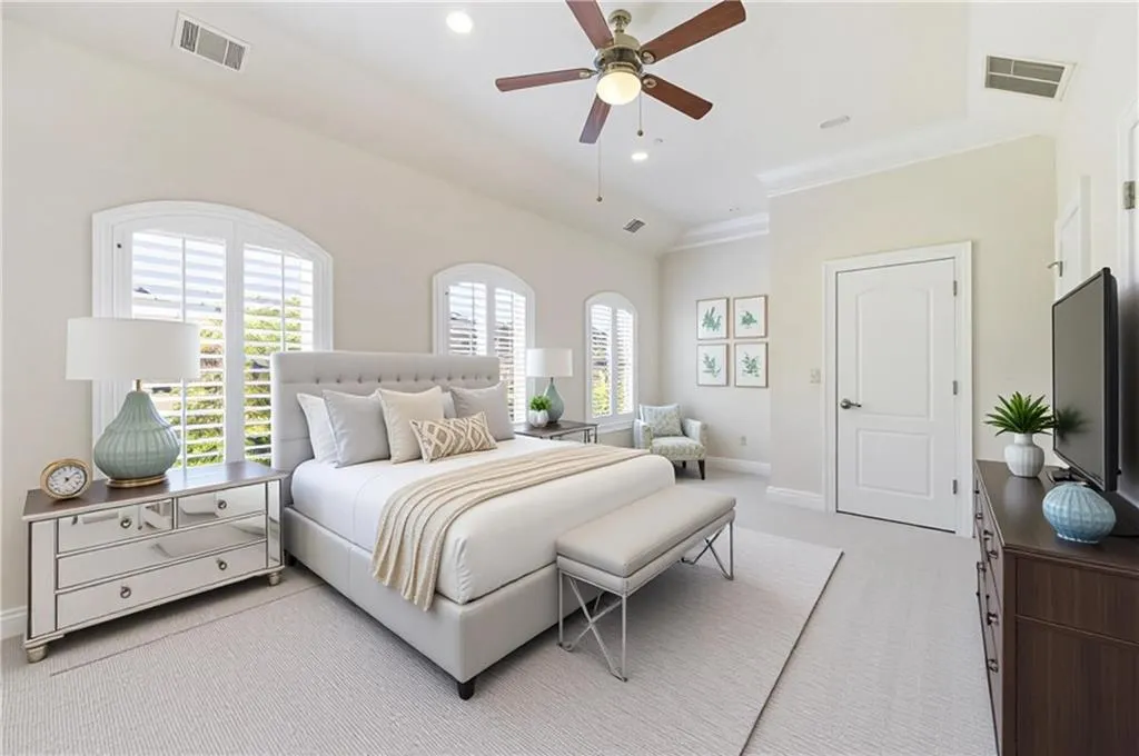 Bedroom with vaulted ceiling, light carpet, a ceiling fan, and recessed lighting
