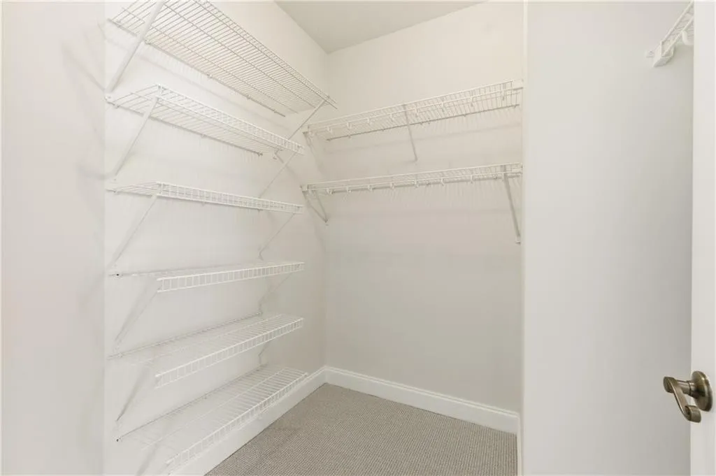 Walk in closet featuring light carpet