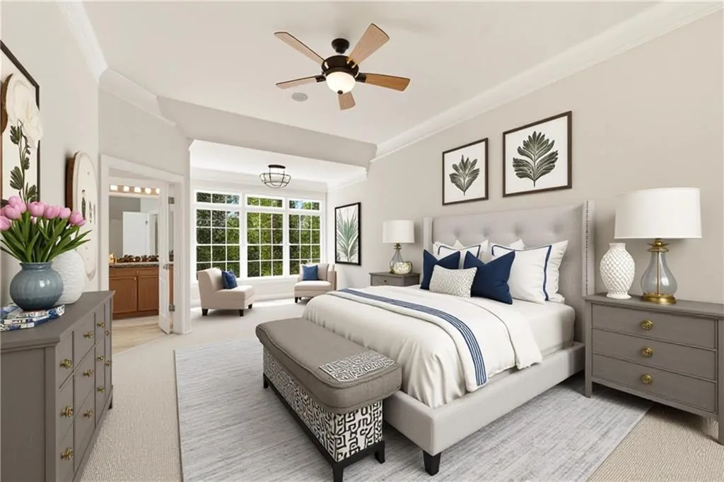 Bedroom featuring ornamental molding, light colored carpet, a ceiling fan, and ensuite bath