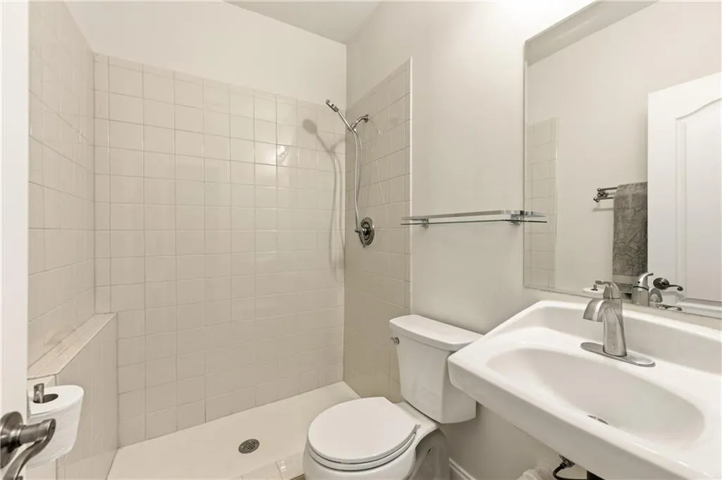 Full bathroom featuring tiled shower