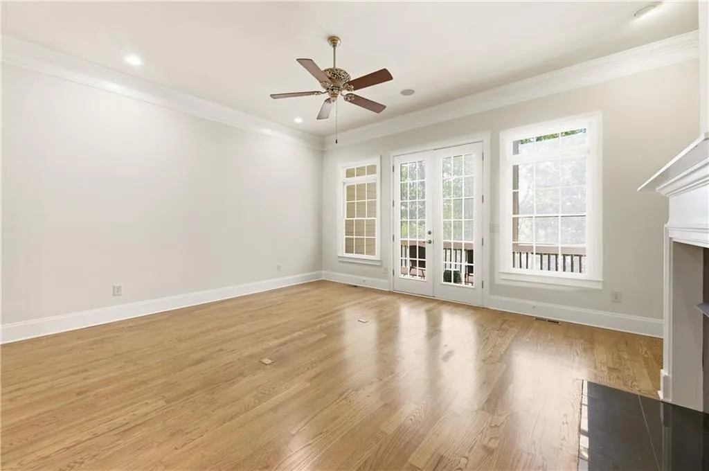 Unfurnished living room with french doors, light wood-style flooring, ceiling fan, ornamental molding, and recessed lighting