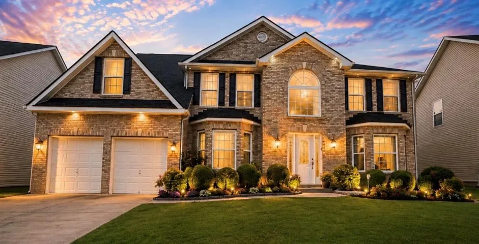 Stone veneer and brick facade with a two-car garage