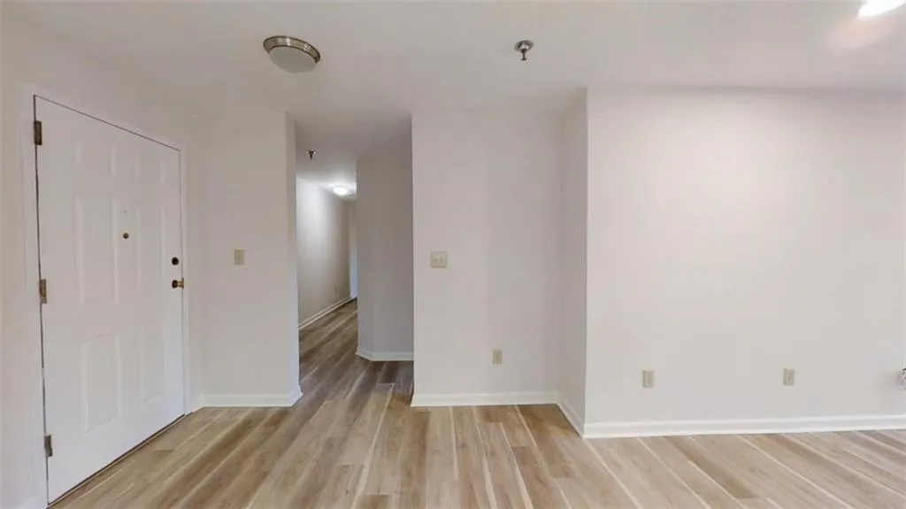 Spare room featuring light wood finished floors and baseboards