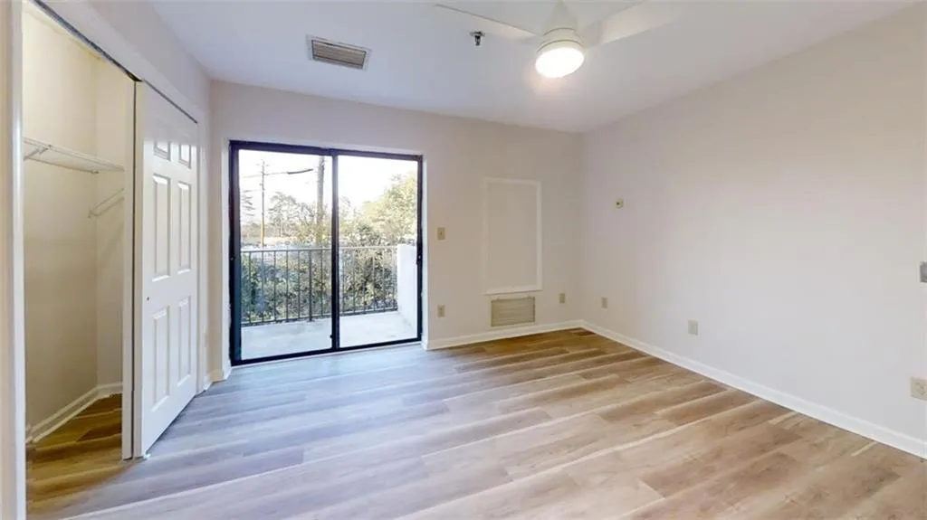 Spare room featuring visible vents, light wood-style flooring, and baseboards