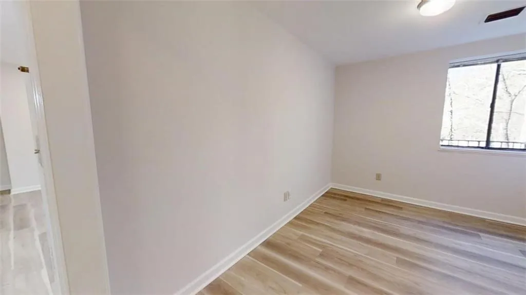 Spare room featuring light wood finished floors and baseboards