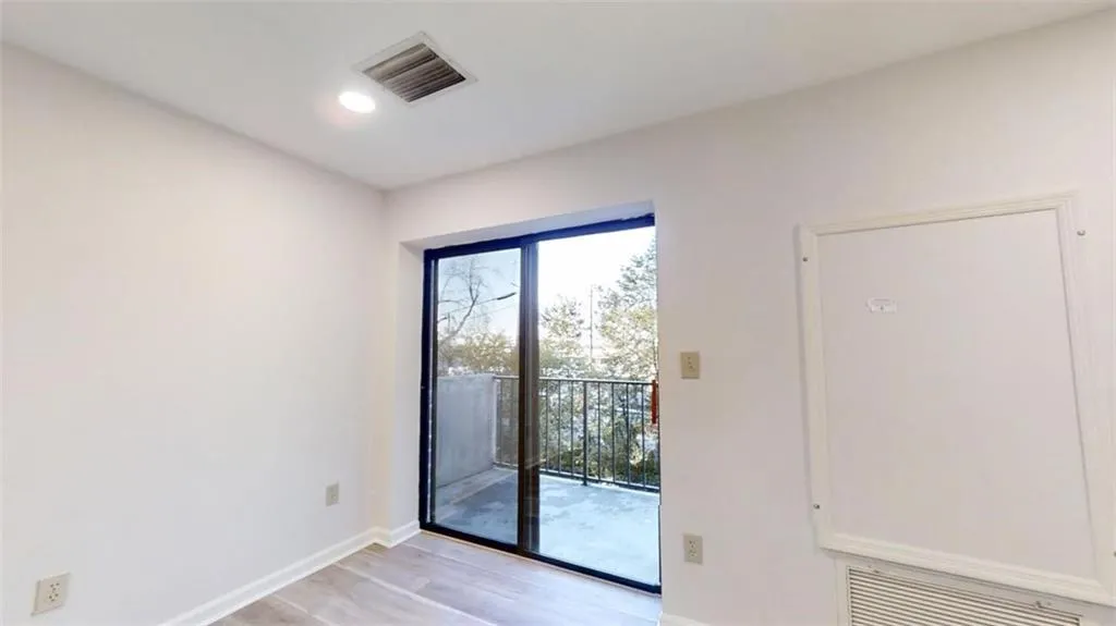 Unfurnished room with baseboards, visible vents, and light wood-style flooring
