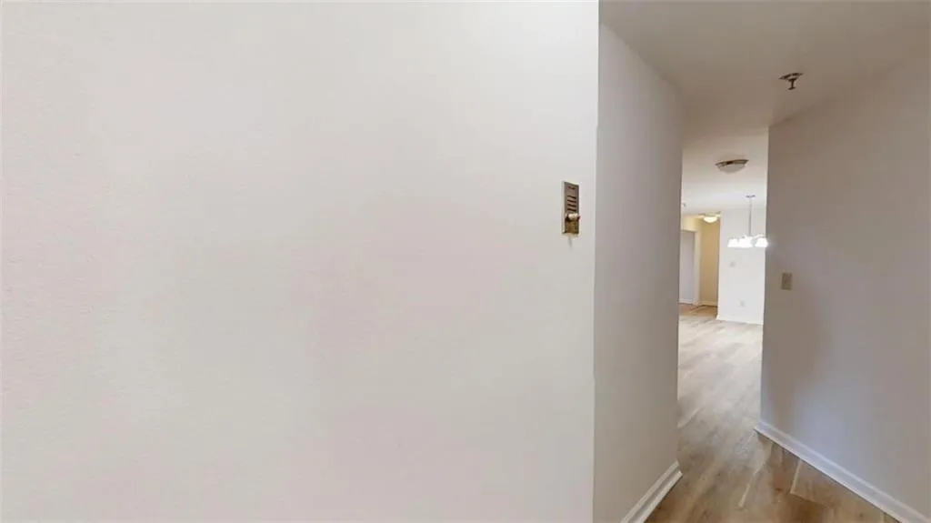 Hallway featuring baseboards and light wood-style floors