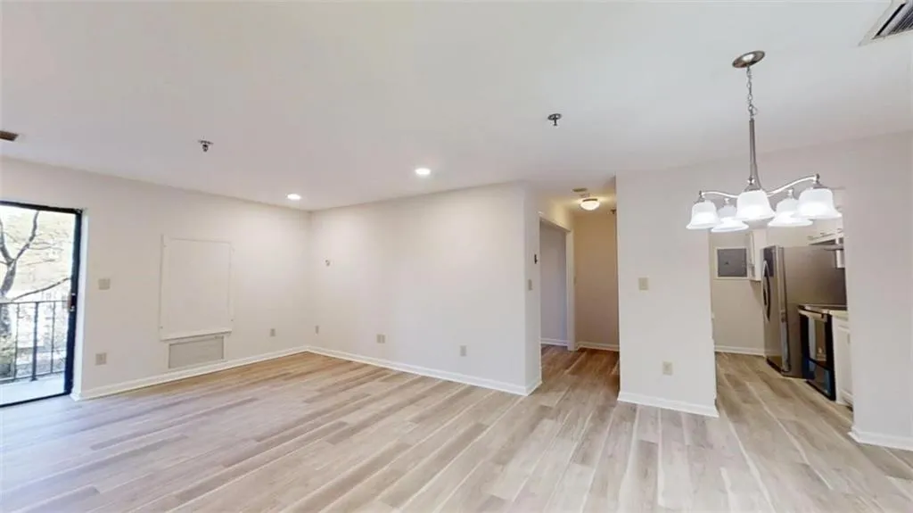 Empty room featuring baseboards, recessed lighting, visible vents, and light wood-style floors