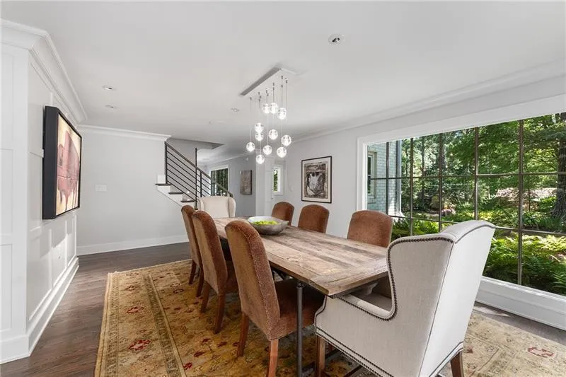 Dining room with crown molding, dark wood-style floors, stairway, a chandelier, and recessed lighting