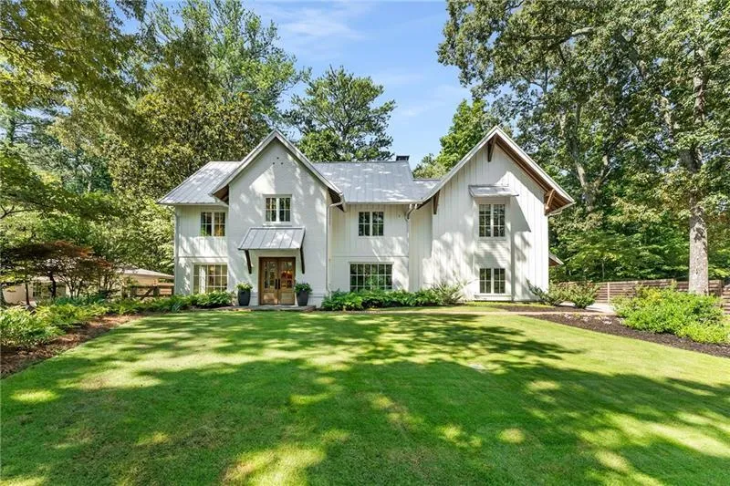 Modern inspired farmhouse with board and batten siding, a metal roof, and french doors