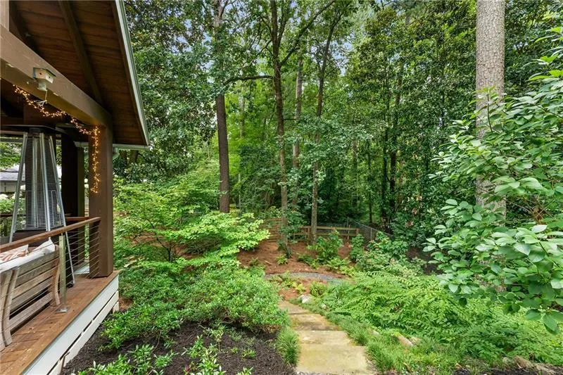 View of yard with path down to basement entrance