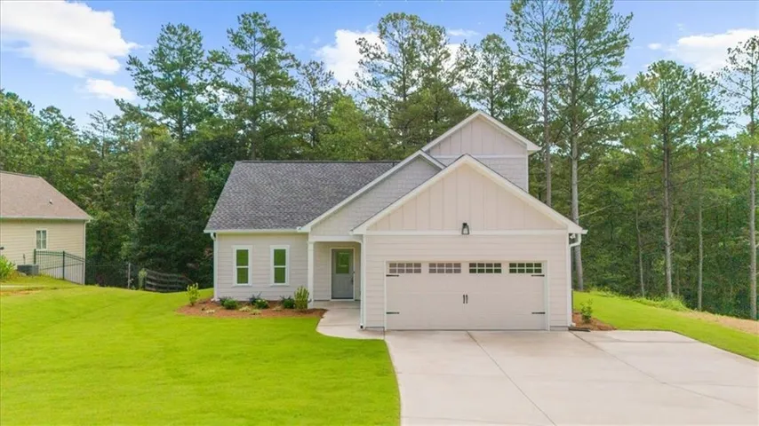 Contemporary exterior with board and batten siding and shingle accents