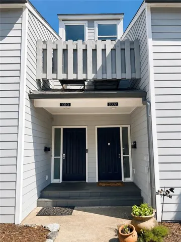 Light gray horizontal siding exterior with a covered entry