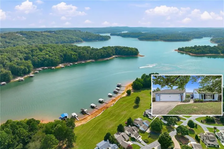 Expansive waterfront property featuring multiple private boat docks along a wide lake