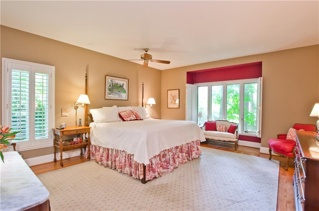 The spacious  main floor primary suite with lots of natural light
