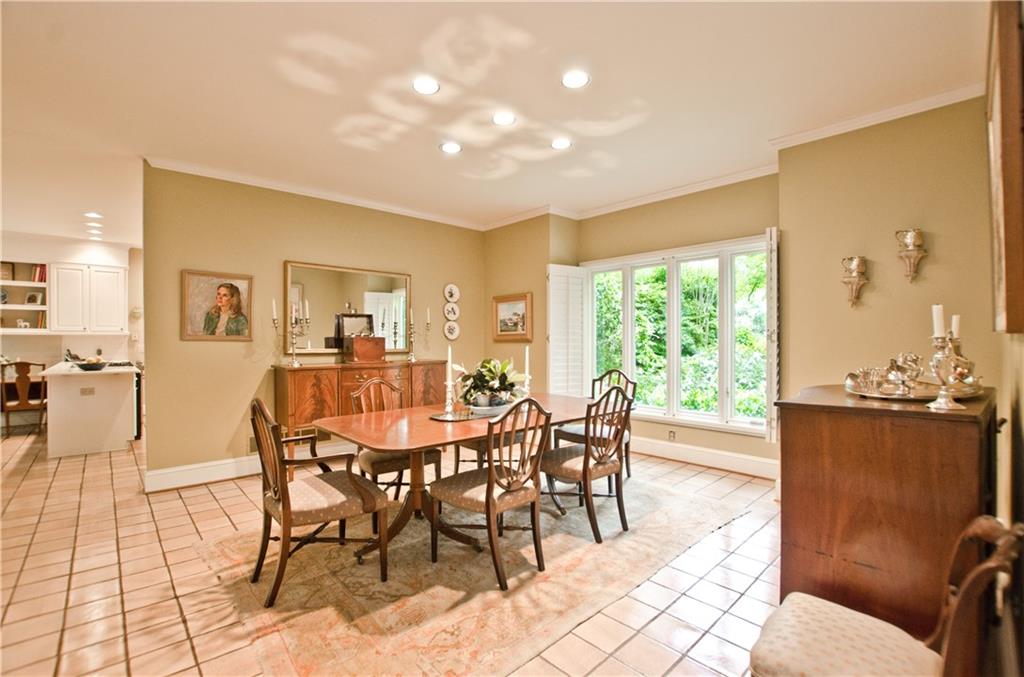 The spacious dining area seats 12+ and faces the front garden