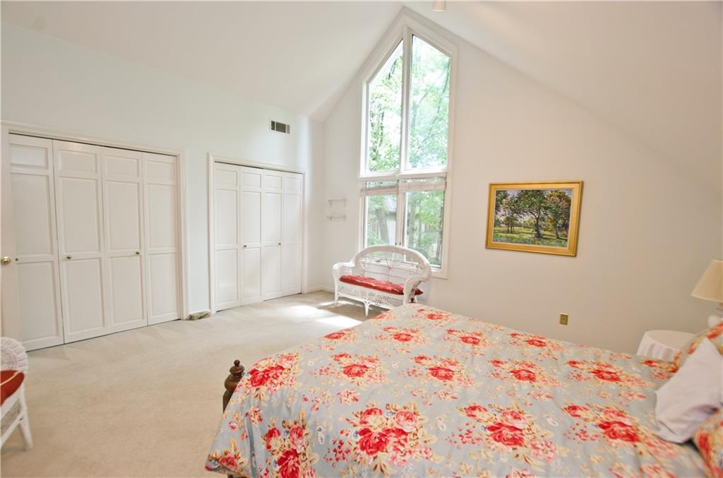 2nd story bedroom with vaulted ceiling and 2 closets