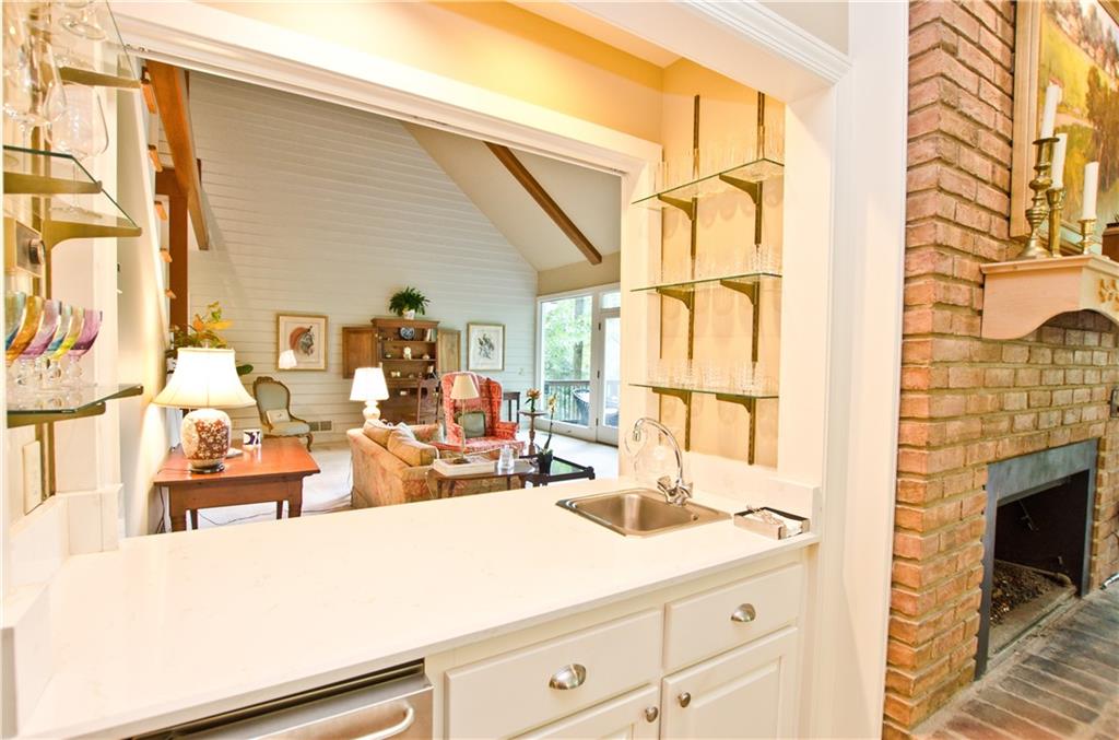 Wet bar that opens to the kitchen and den and living room