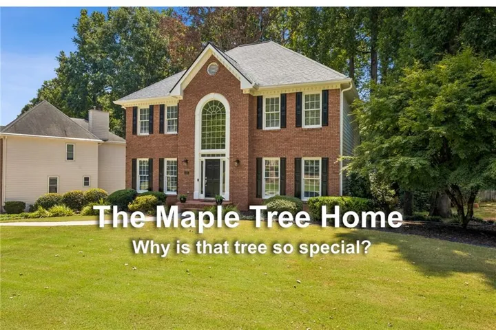 Two-story brick exterior with a prominent arched window, black shutters, and a well-maintained lawn