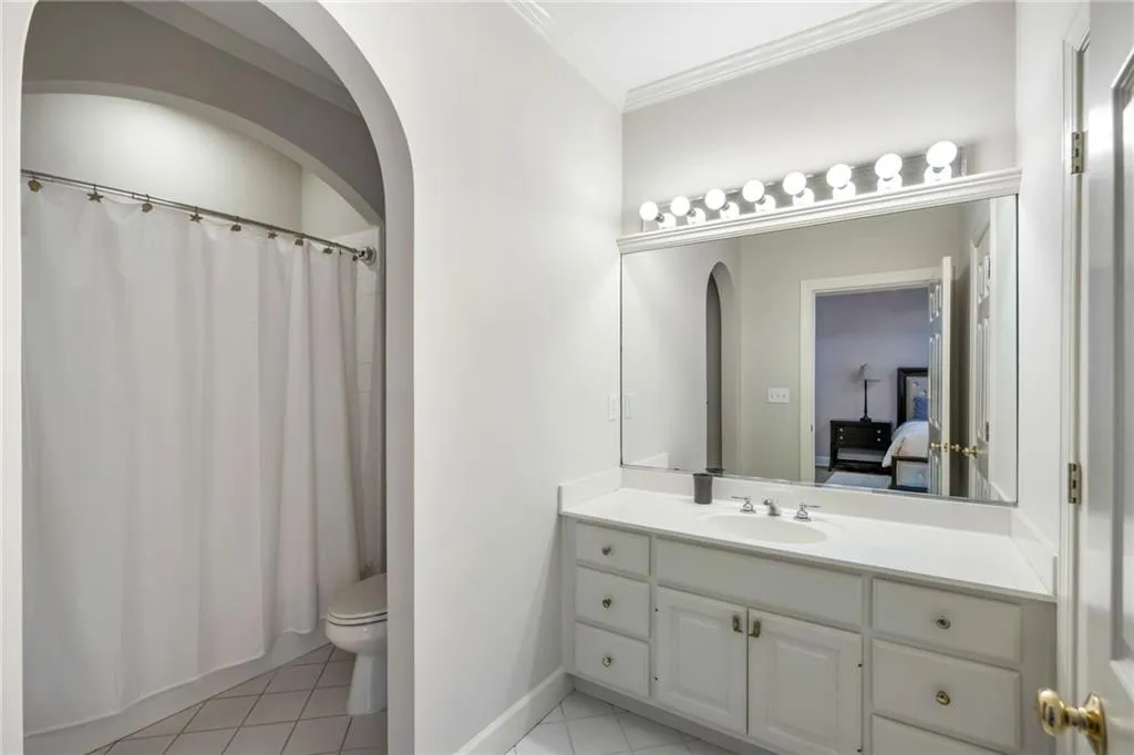 White vanity with integrated sink, chrome faucet, and ample storage