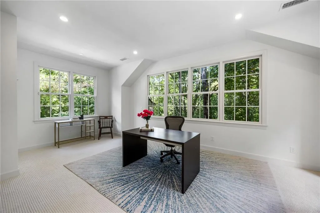 Bright room with recessed lighting, multiple windows, and light-colored carpet