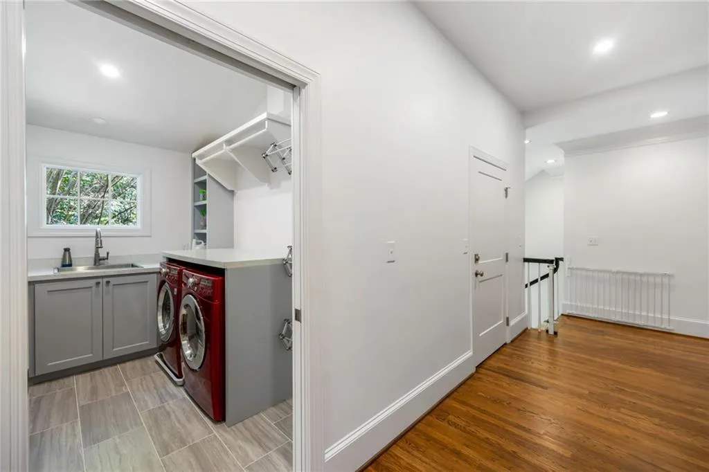 Laundry area with built-in cabinetry, sink, and countertop