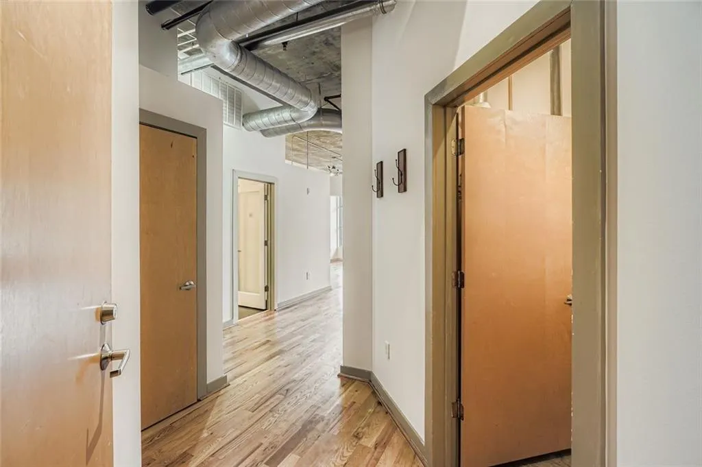 Hall with light wood-style flooring and baseboards