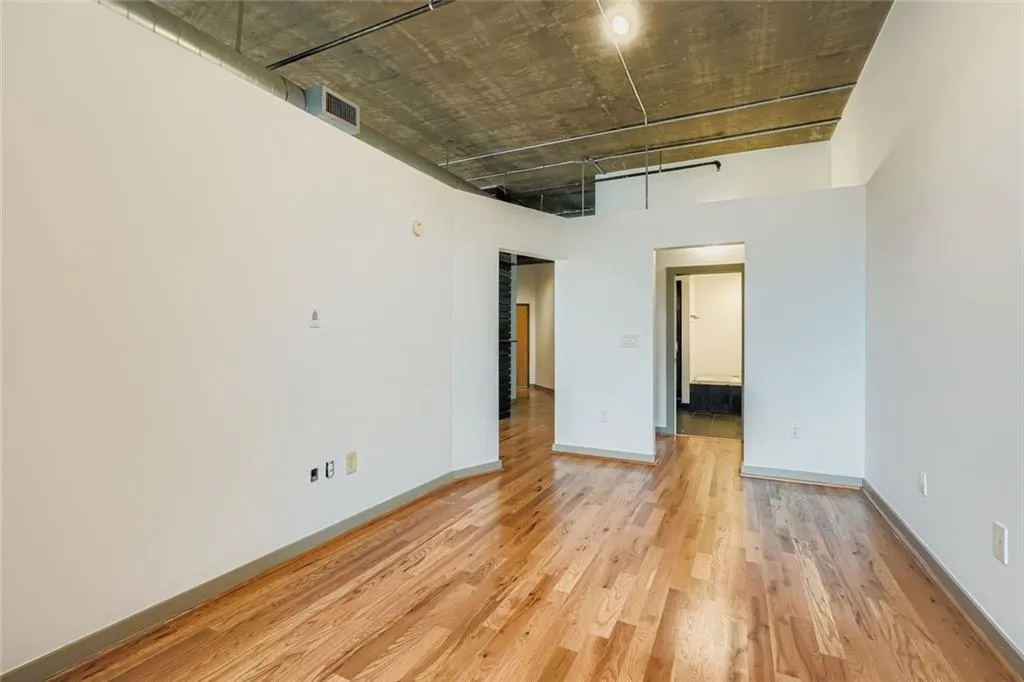 Unfurnished room with light wood-style floors and baseboards