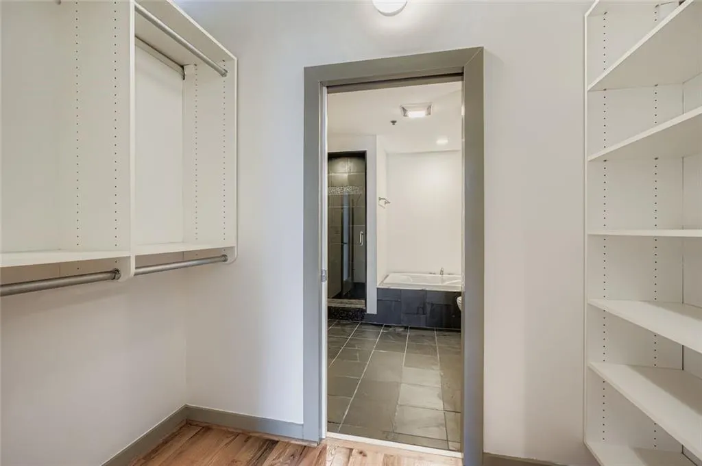 Walk in closet featuring light wood finished floors