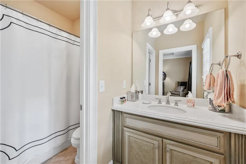 Bathroom with vanity, a shower with curtain, and tile patterned floors