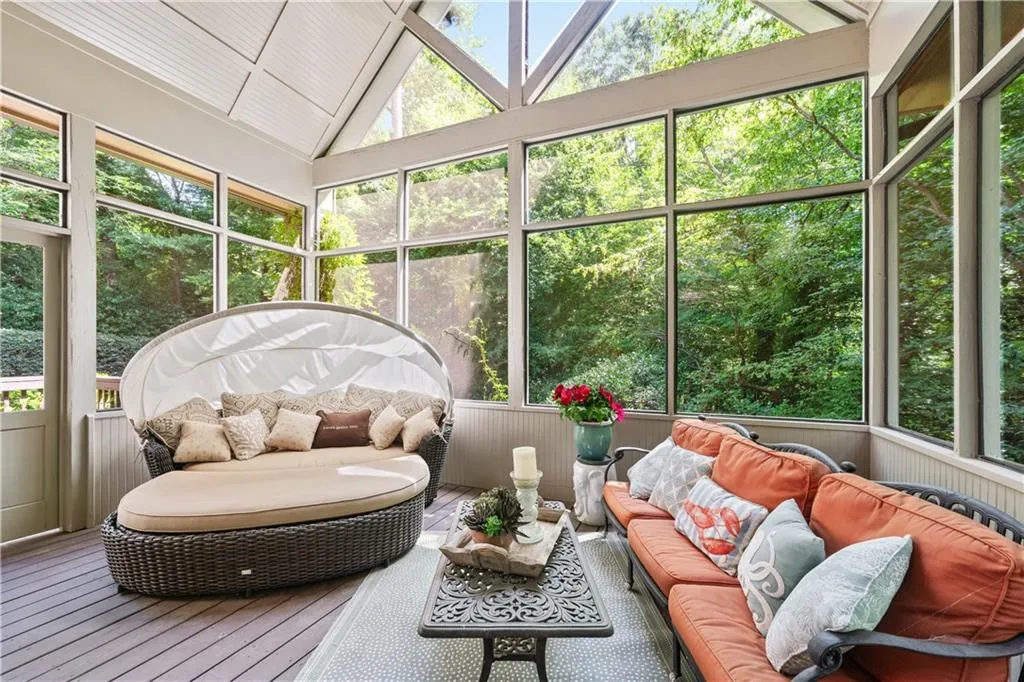 Sunroom / solarium with an outdoor hangout area and lofted ceiling