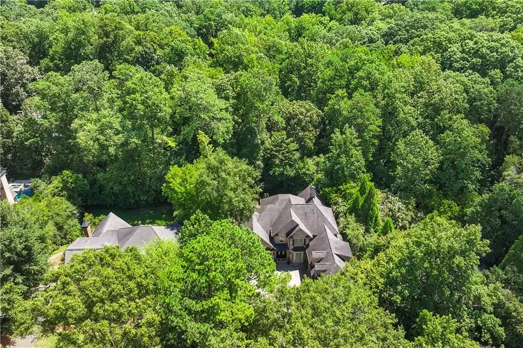View of subject property featuring a heavily wooded area