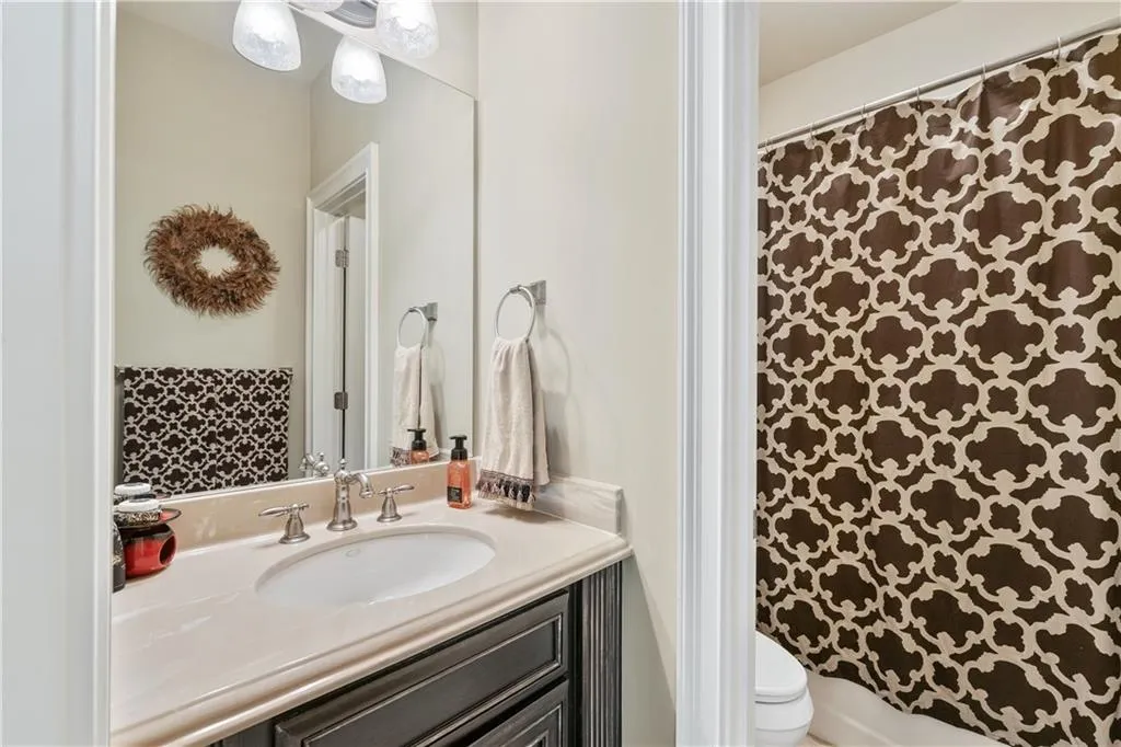 Bathroom featuring vanity and curtained shower
