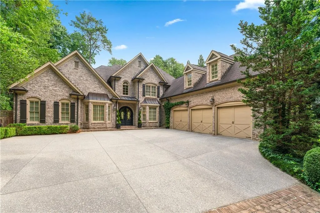 French country style house with concrete driveway and a garage