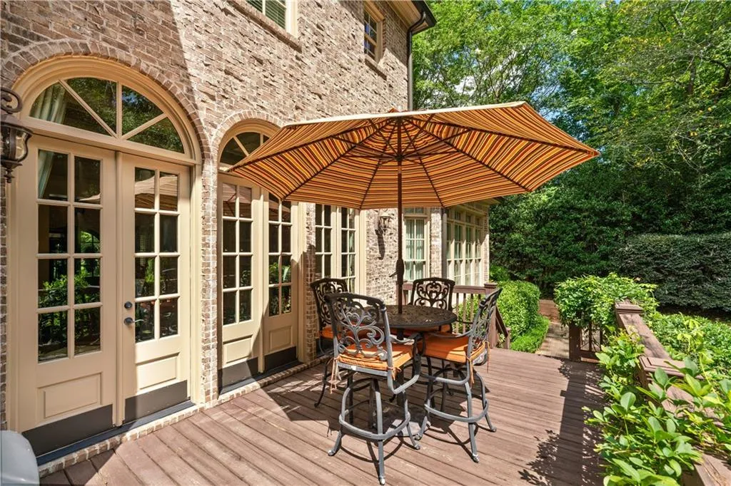 Wooden terrace featuring french doors and outdoor dining area