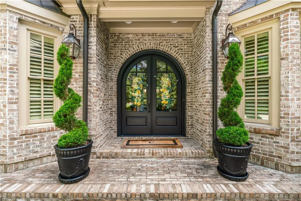 Doorway to property featuring french doors and brick siding