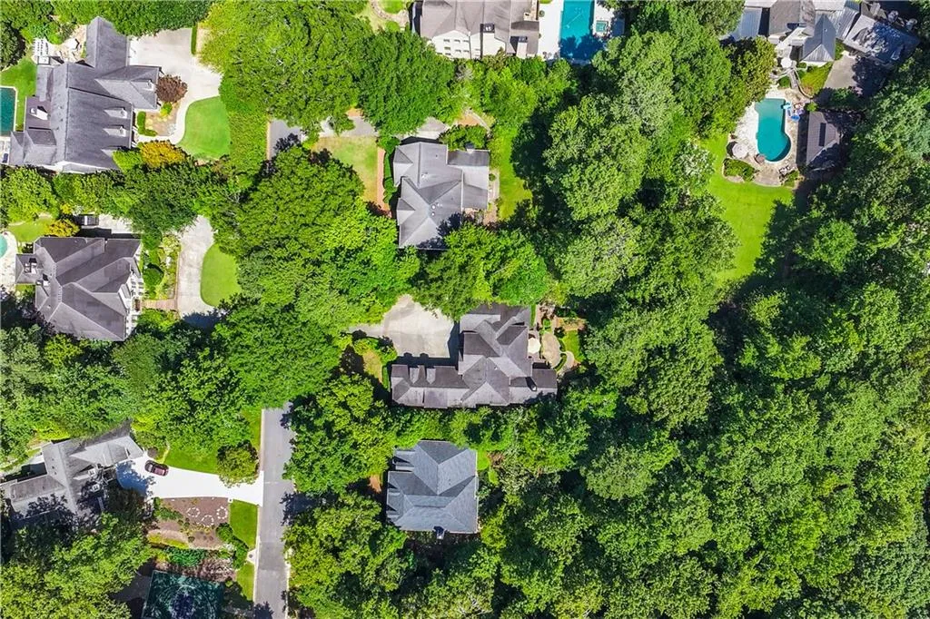 Aerial view of residential area featuring a pool