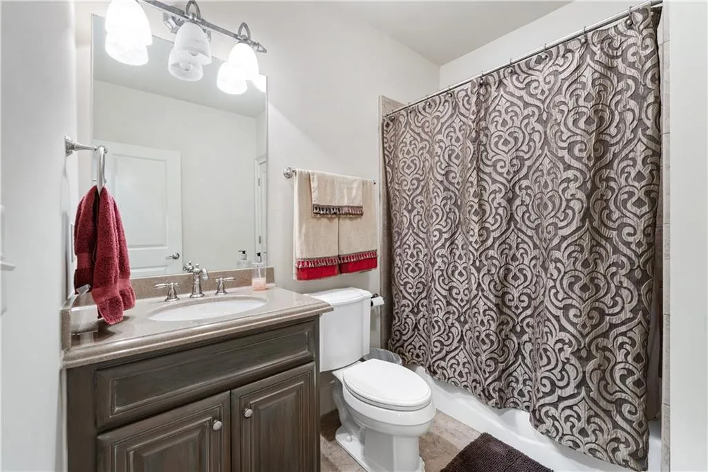 Full bathroom with vanity and shower / bathtub combination with curtain