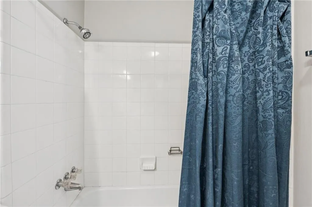 Bathroom featuring shower / bath combination with curtain