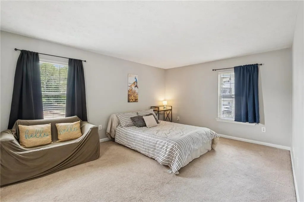 Carpeted bedroom with baseboards and a textured ceiling