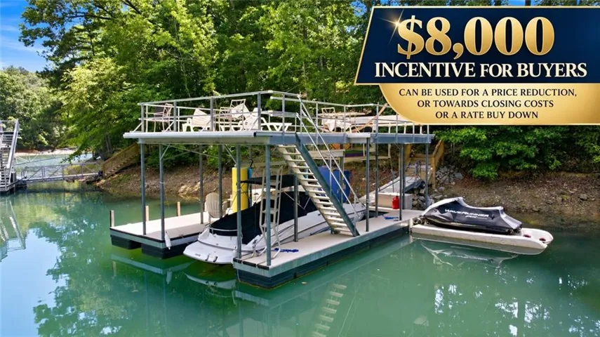 Two-story boat dock featuring a covered boat slip, second-level decking, and a separate floating jet ski dock