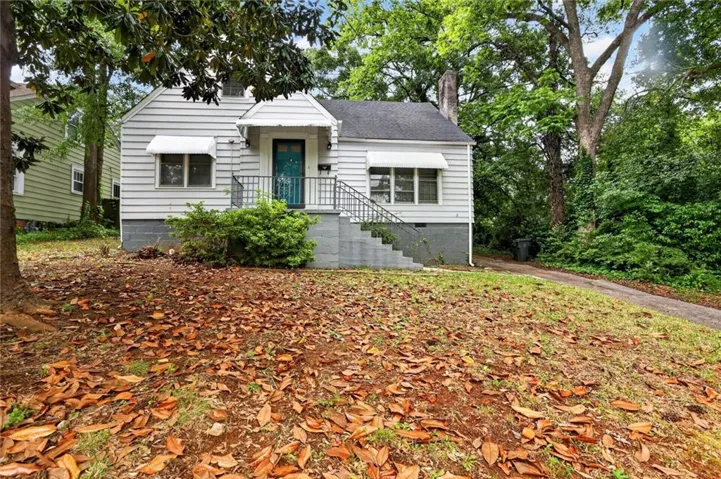 White siding exterior with a dark-colored roof